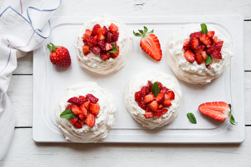 Delicious Pavlova cake with meringue and fresh strawberries