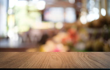 Empty dark wooden table in front of abstract blurred bokeh background of restaurant . can be used for display or montage your products.Mock up for space.
