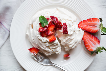 Delicious Pavlova cake with meringue and fresh strawberries