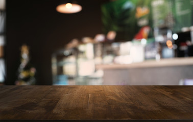 Empty dark wooden table in front of abstract blurred bokeh background of restaurant . can be used for display or montage your products.Mock up for space.