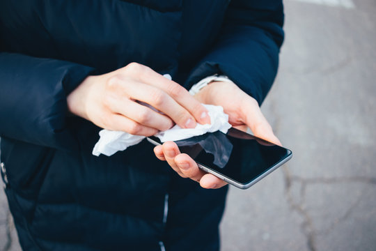 Woman's Hands Wipe Smartphone Screen