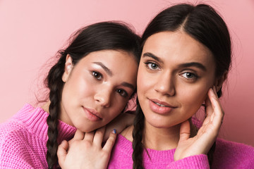 Image of two attractive teenage girls with braids looking at camera - Powered by Adobe