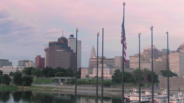 Aerial: American flag at Joe Curtis Point on Mud Island River Park. In the back is downtown Memphis. Tennessee, USA. 26 June 2019