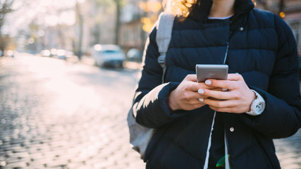 Unrecognizable young woman using mobile phone