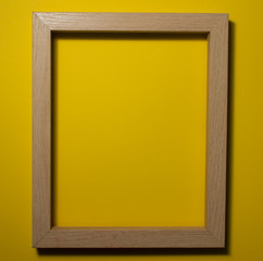 Fototapeta premium Wooden frame on a colored background. Space for copy-paste. Top view of a rectangular frame