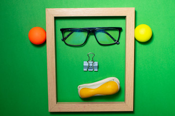 Wooden frame in the shape of a human face, on a colored background. Space for copy-paste. Top view of a rectangular frame