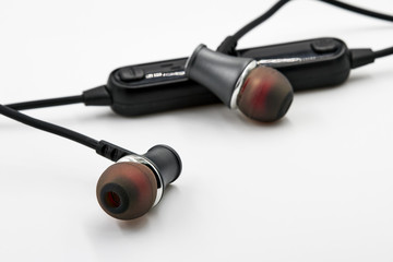 Black red Headset with Remote Control on white background. Closeup, selective focus