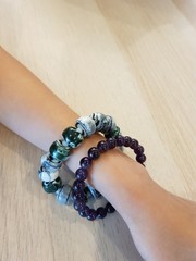 Closeup of beautiful bead bracelets on young boy's arm.  Recommended ornament concept.