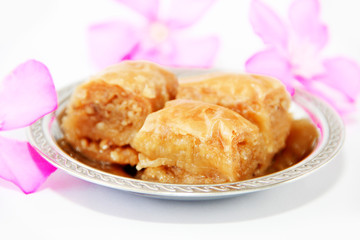 traditional oriental sweet baklava on a decorative plate
