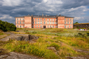 Finland, Sveaborg, Suomenlinna: Panorama view with big building as part of the former prison in the center of the famous Finnish island in the background - concept religion Christianity history travel