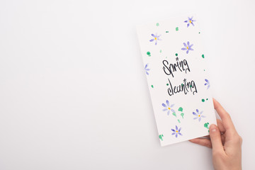 cropped view of woman holding spring cleaning card on white background