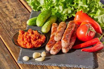 Grilled meat sausages with vegetables