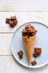 Ice cream on a wooden background. Waffles and chocolate