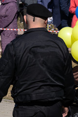 A military man in a black beret with tears in his eyes and cheek covered his face in misery with...