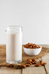 Super Food - A glass of almond milk for a healthy diet. Trending food, vertical photo. Place for your text.