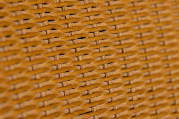 Selective focus on convex shaped woven surface of natural golden colored reed