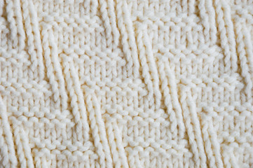 The texture of the fabric. White knitted pattern. background.