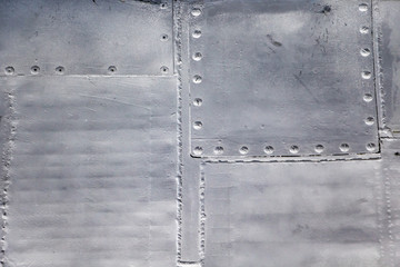 Aircraft skin close up. Rivets on gray metal.