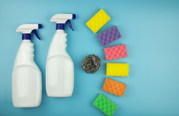 two sprays and washcloths on a blue background - the concept of cleaning the room
