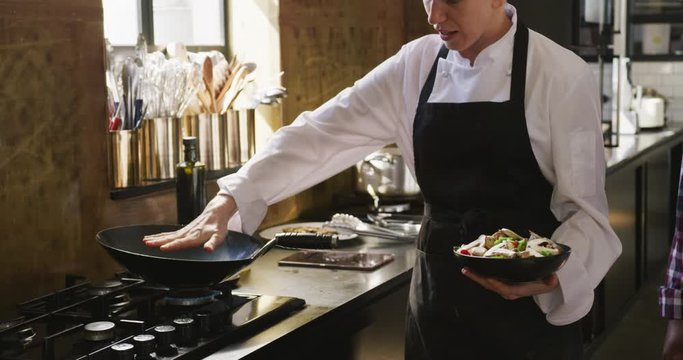 Chef checking if the pan is hot enough