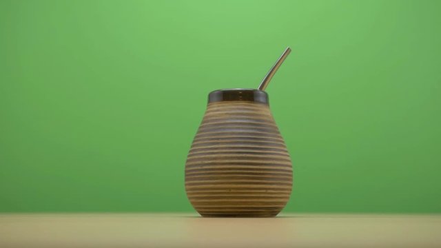 healthy yerba matte bombilla on green screen background slide to the right