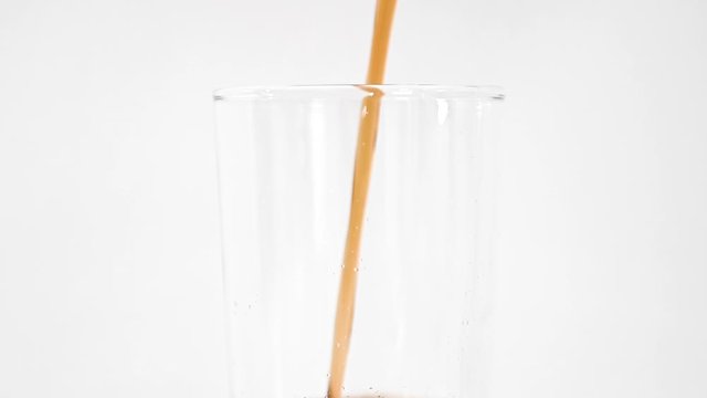 Cold cola being poured into a tall glass from the tap, on a white background, stock footage by Brian Holm Nielsen