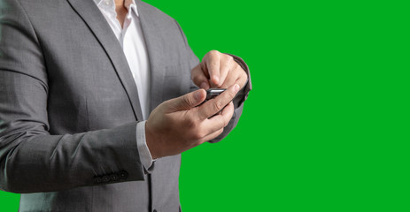 Business man holding mobile phone and have green screen for cut to insert background