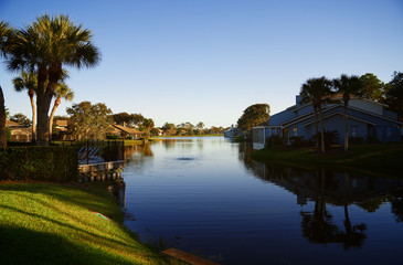 Fototapeta na wymiar View on suburb district with pond and palm trees. Florida, USA