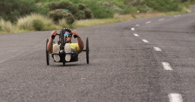 Disabled man riding a recumbent bicycle