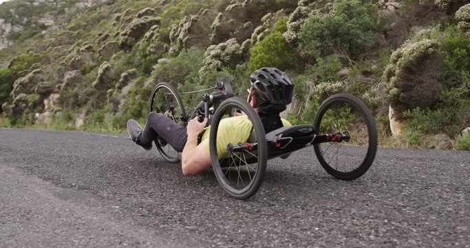 Disabled man riding a recumbent bicycle