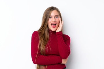 Teenager blonde girl over isolated white background with surprise and shocked facial expression