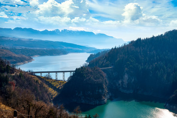 View to the Santa Giustina Lake in winter with vines in the foreground, Trentino, Italy