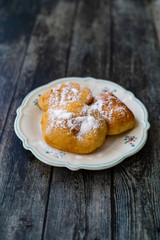 Mandazi is a slightly sweet East African Street Food; spicy, airy yeast doughnut dough made with coconut milk, flavored with cardamom and grated fresh coconut.