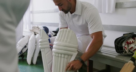 Cricket players preparing in the locker room