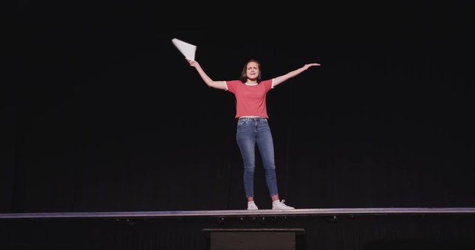 Caucasian teenage girl in the high school auditorium preparing for a performance