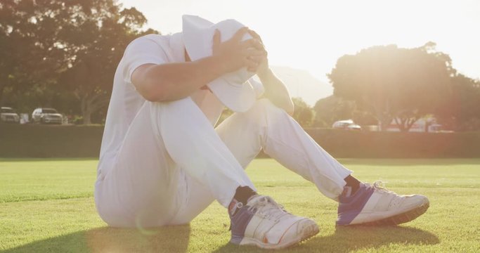 Cricket player holding his head after the match
