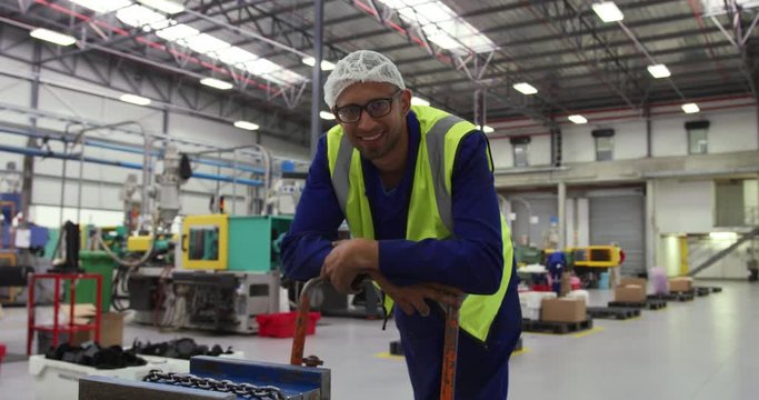 Warehouse worker smiling and looking at camera