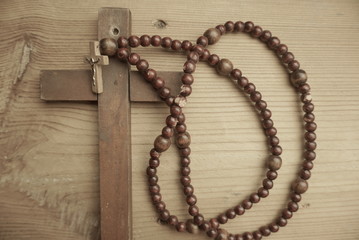 Fototapeta na wymiar wooden cross and wooden rosary