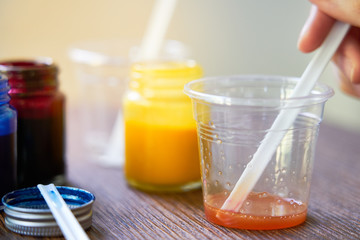 Mixing colorful of resin chemical in plastic cup, Process of making accessory from resin