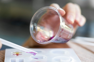 Drop purplish resin into mold, Process of making accessory from resin