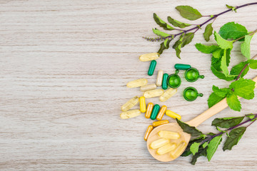 Herbal medicine, vitamin and supplements nutrition for good healthy on wooden background, medicine and drug concept