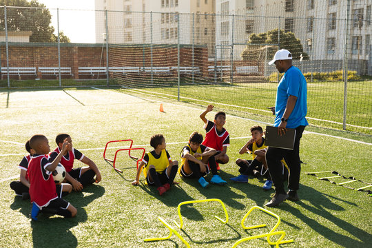 Soccer players listening to their coach