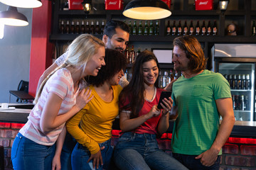 Friends laughing after taking selfies