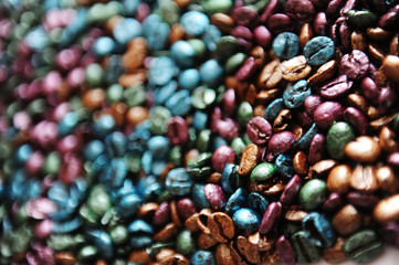 Multi-colored painted pearl coffee beans texture background.