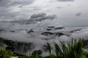 Blurred nature background of mist covering the trees on the mountains, scenic spots along the way, cool breezes