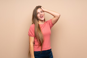 Teenager blonde girl over isolated background laughing