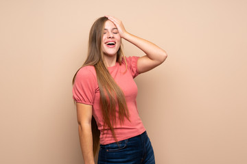 Teenager blonde girl over isolated background laughing