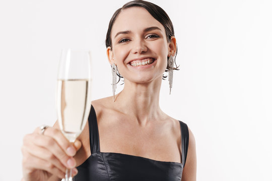Image of young happy woman smiling and holding glass of champagne