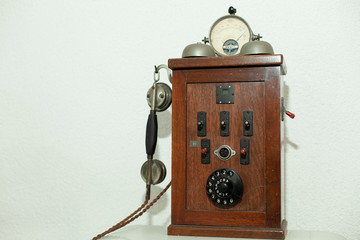 wooden historic rotary dial phone on white background