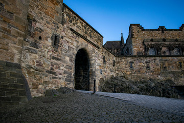 inside the castle in edimburgh city, scotland on the rocks with a blue sky at sunset